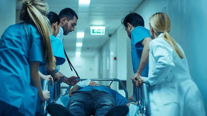 Medical team rushing patient on a gurney through hospital corridor