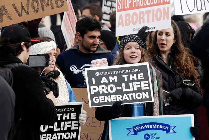 shutterstock_1291055839 Group of protesters holding pro-life signs at a rally