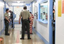 DHS Bets On Pain — Where’s The Data? Corrections officers escort an inmate in a jail hallway