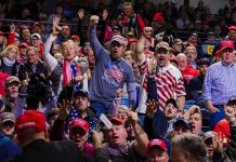 Election Interference Escalates — Again Crowd of supporters cheering at an indoor political rally