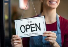 Salon Showdown Over ‘Israeli’ Stuns Virginia Shop worker holding an open sign