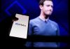 Teen Safety Ultimatum Shocks Meta smartphone showing Meta logo in front of a blurred speaker on stage