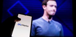 Teen Safety Ultimatum Shocks Meta smartphone showing Meta logo in front of a blurred speaker on stage