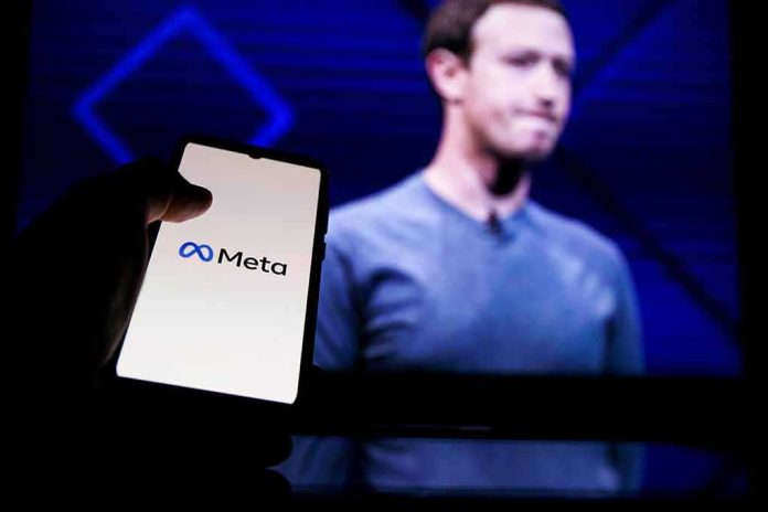shutterstock_2146826979 smartphone showing Meta logo in front of a blurred speaker on stage