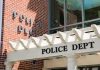 Police department entrance with pergola and brick wall