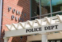 Cop Lies Exposed — Conviction Erased Police department entrance with pergola and brick wall
