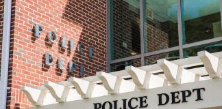 Police department entrance with pergola and brick wall