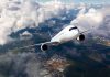 Commercial jet airliner flying above clouds