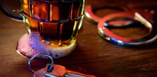 Seized Beer Leads to a High Stakes Permit Fight House keys on bar beside beer mug and handcuffs