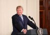 man at podium with presidential seal