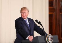 man at podium with presidential seal