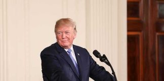 Currency Shock: Living President On A Coin man at podium with presidential seal