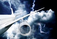 Passenger airplane flying through thunderstorm with lightning