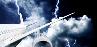 Passenger airplane flying through thunderstorm with lightning