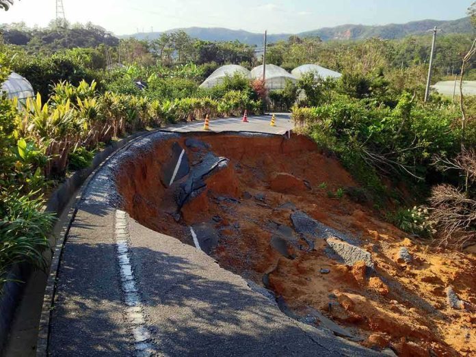 collapsed rural road with large sinkhole