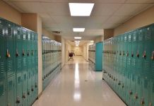 Disturbing Discovery Triggers Coach Arrest School hallway with rows of teal lockers