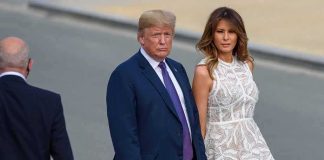 Donald Trump and Melania Trump walking outdoors in formal attire