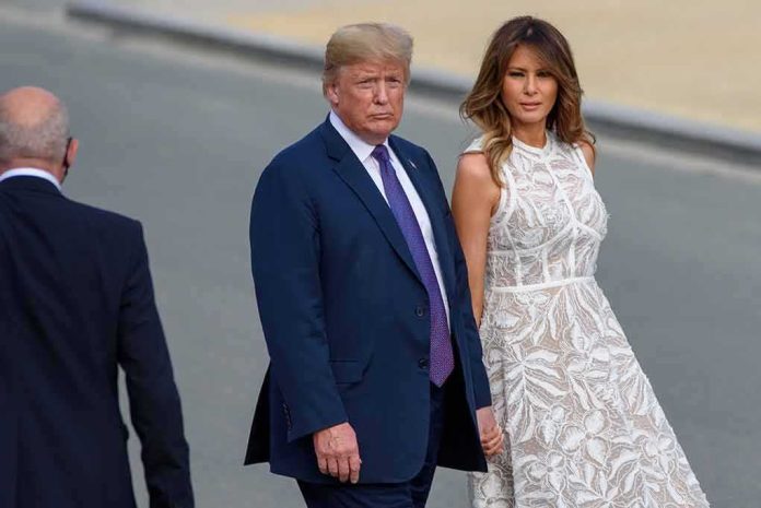 shutterstock_1222732735 Donald Trump and Melania Trump walking outdoors in formal attire