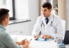 Young Men Hit With SHOCKING Symptoms Doctor explaining glucose meter to patient during consultation