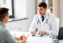 Doctor explaining glucose meter to patient during consultation