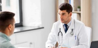 Young Men Hit With SHOCKING Symptoms Doctor explaining glucose meter to patient during consultation