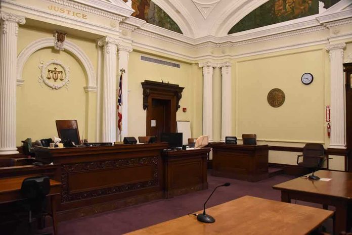 shutterstock_1292266861-1 empty courtroom with judge's bench and columns