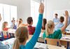 Court Freeze Jolts Parental Notification Push Students raising hands in a classroom