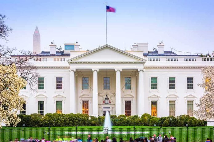 shutterstock_1627056523 The White House facade with fountain and flag