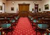 Courtroom with wooden benches facing the judge's bench