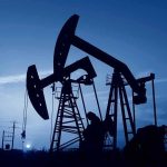 Oil pumpjacks silhouetted against a twilight sky