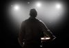 A Longtime Las Vegas Star Is Hospitalized Speaker on stage under bright spotlights