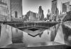 What’s Missing From Trump’s 9/11 Account A memorial water feature surrounded by tall buildings in a city
