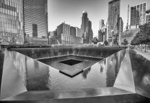 What’s Missing From Trump’s 9/11 Account A memorial water feature surrounded by tall buildings in a city
