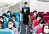 Duct-Taped First Class Meltdown Sparks Instant Firing Airline passengers wearing masks seated on a flight