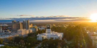 California State Capitol building at sunrise with surrounding downtown skyline