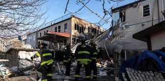 New Video Changes Focus Of Deadly Fire Investigation Firefighters assess damage at a collapsed residential building