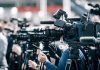 Fast-Food Supply Chain Backfires Broadcast cameras on tripods at a press event