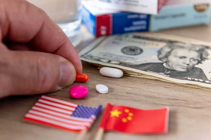 Hand picking an orange pill beside US and China flags and cash