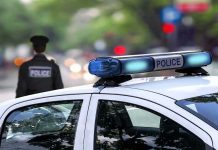 DUI Bombshell Upends Washington Race police car roof with blue emergency lights