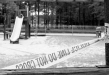 Queens Park Panic—Shooter Still Loose Playground closed off with caution tape in black and white