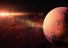 Mars planet with sun flare in deep space