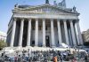 Reporters and photographers gathered outside a neoclassical courthouse