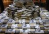 Stacks of U.S. hundred-dollar bills arranged in a pyramid