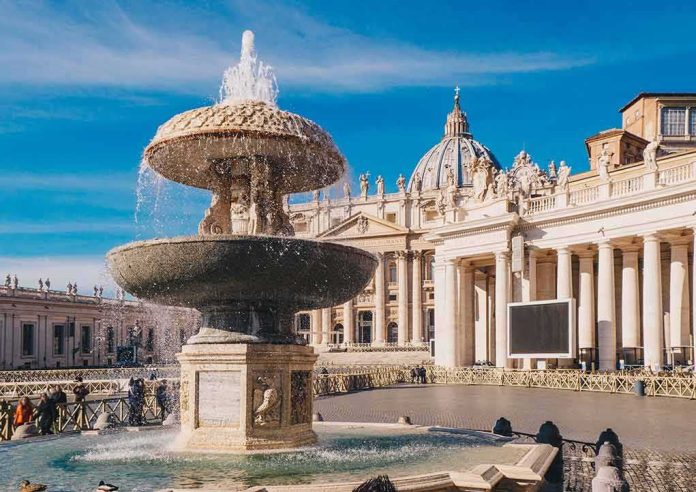 shutterstock_1030169698 Stone fountain in front of a grand basilica with dome and colonnade