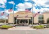 Press Room Bombshell: Bar Exam Bomb Drops American flags at half-staff around a library entrance