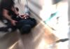 person being restrained on the ground in a hallway
