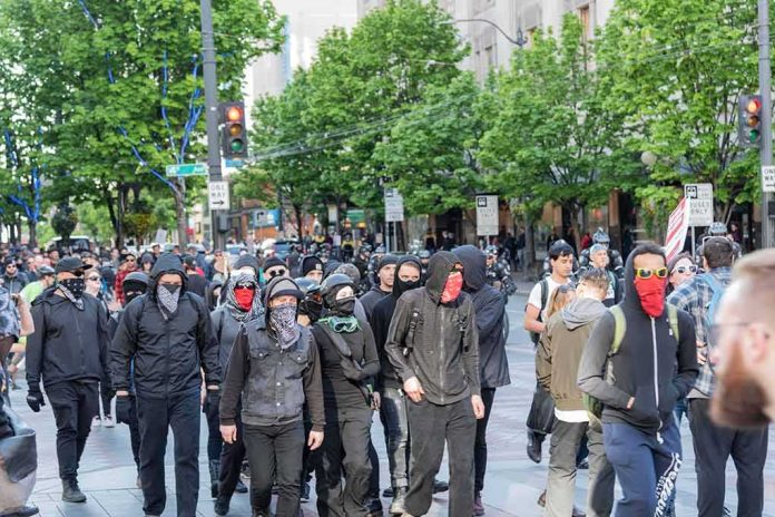 group of masked protesters walking through a city street