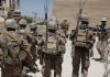 soldiers in desert fatigues with radio packs and antennas