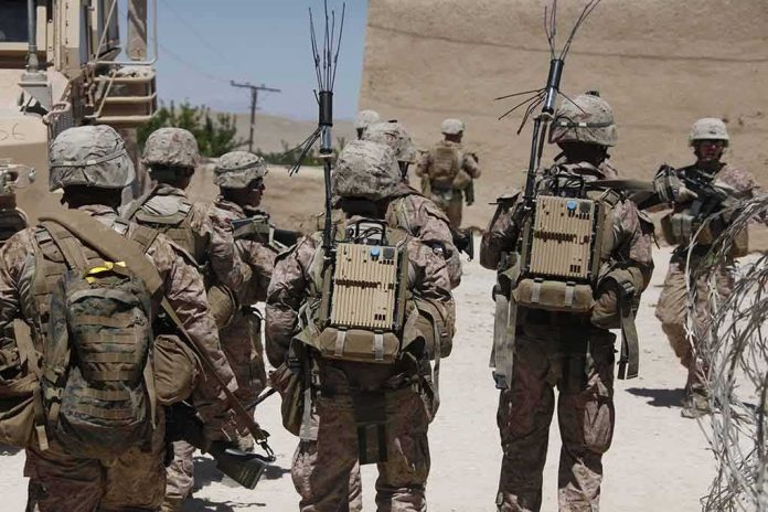 shutterstock_1470887795 soldiers in desert fatigues with radio packs and antennas