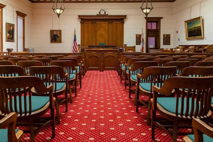 shutterstock_1631139556-1 Courtroom with wooden benches facing the judge's bench